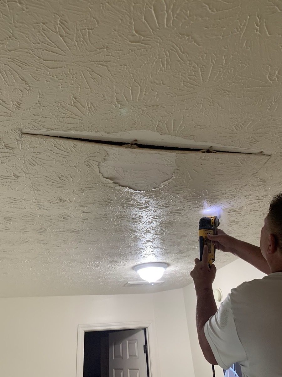 Repairing and patching a textured drywall ceiling with a power tool