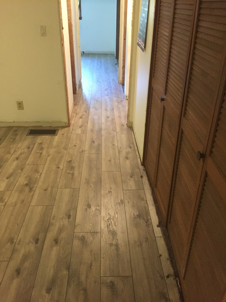 New laminate wood flooring installed down a hallway