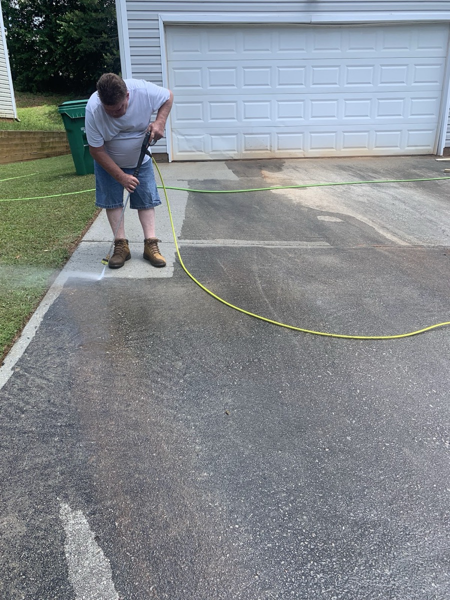 Pressure washing a concrete driveway clean